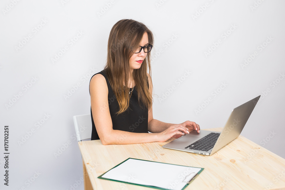 business concept - businesswoman working on laptop in the office business concept - businesswoman working on laptop in the office