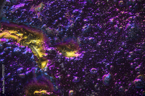 Purple and Yellow psychedelic metallic texture, microscopic background of titanium nickle coating on scrap metal.  photo