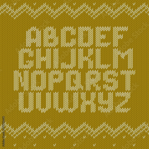 Knitted alphabet on yellow background. Christmas crochet font on knitted classic ornament pattern. All the letters are on different layers, it is convenient to produce words and sentences photo