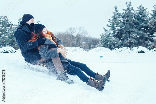 young couple in love enjoying a winter vacation and having fun on a snowy winter day.