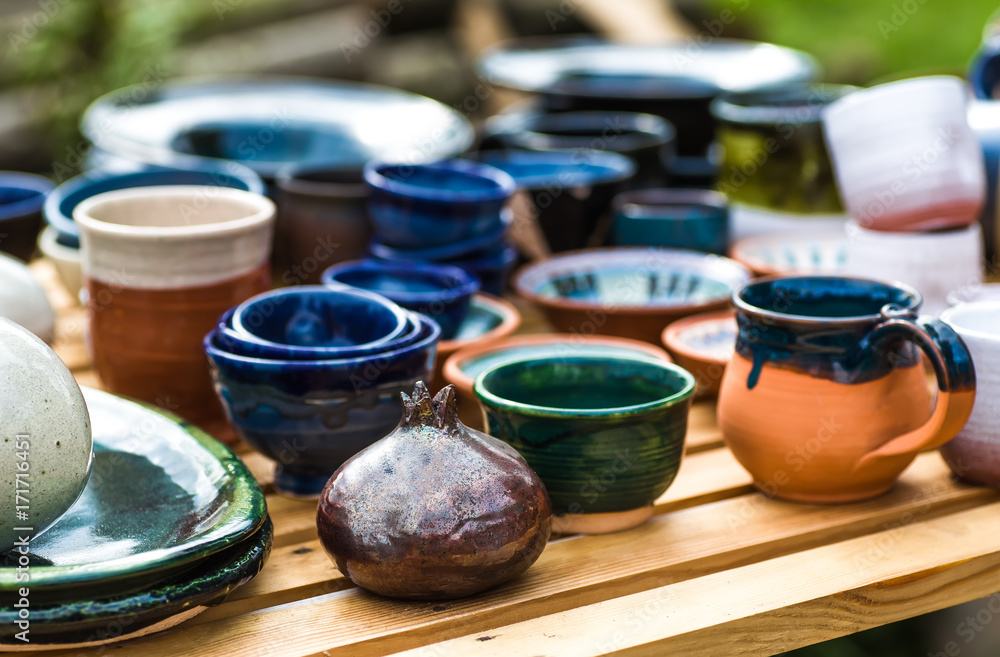 Ukrainian pottery. Pottery museum in Ukrainian village Oposhnya, center of Ukrainian pottery production. Different pottery products: bowls, pitchers, plates in museum. Ukrainian pottery. Pottery museum in Ukrainian village Oposhnya, center of Ukrainian pottery production. Different pottery products: bowls, pitchers, plates in museum.