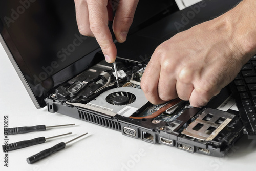 The engineer repairs the laptop, computer . Installs the equipment cpu