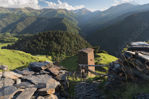 Georgian defensive towers in the mountain village Omalo. Traditional architecture in Georgia. Landscape of Caucasus mountains with Tusheti towers at the forground in summer