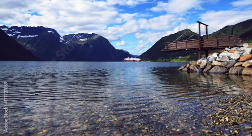 Hjorundfjord, Norway, September 2nd, 2017: Hurtigruten Cruise Ship in Fjord on a beautiful summer day