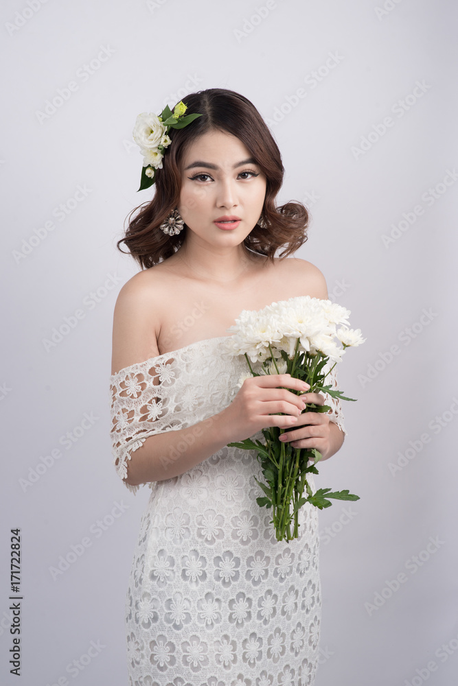 Beautiful asian woman bride on grey background. Closeup portraits with a professional makeup Beautiful asian woman bride on grey background. Closeup portraits with a professional makeup