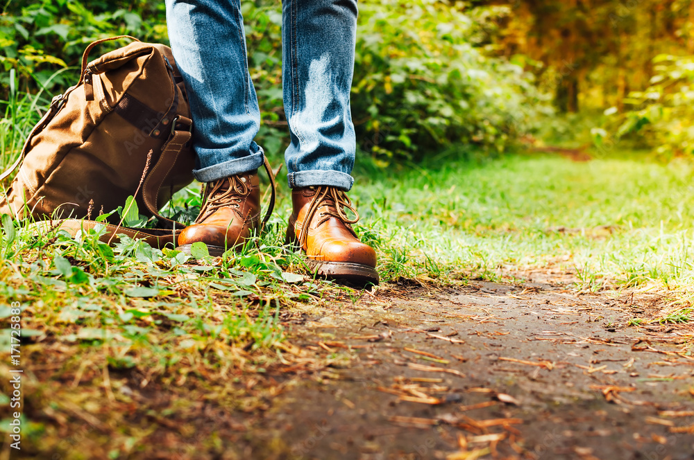 The traveller the man stands on the trail or road in the woods, walking,sunlight, autumn, Hiking. The traveller the man stands on the trail or road in the woods, walking,sunlight, autumn, Hiking.