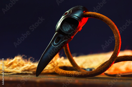 Closeup wooden raven skull as a magic amulet for witchcraft.