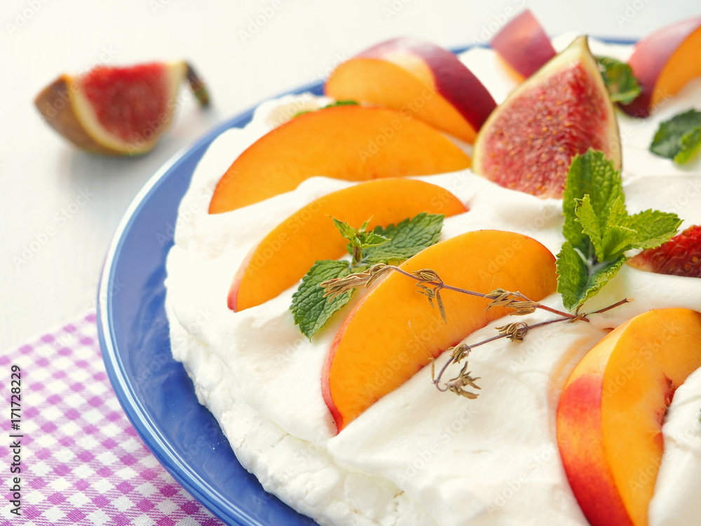 Traditional Pavlova dessert decorated with fruits. Selective focus. Traditional Pavlova dessert decorated with fruits. Selective focus.