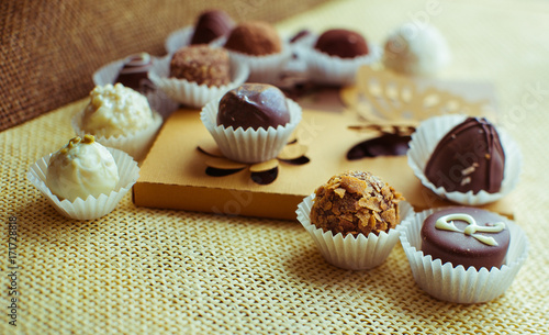 Delicious chocolates stand on paper box with batterflies photo