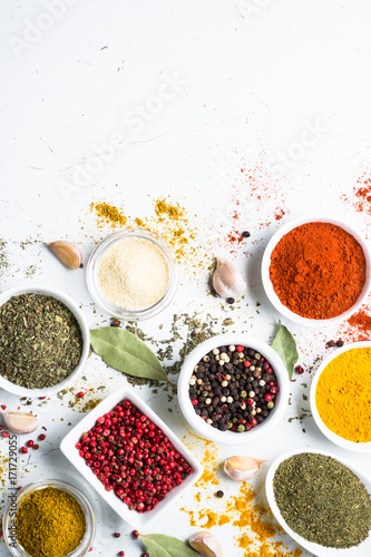 Set of spices in a bowls on white background.