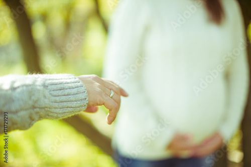 Man reaches out his hand in warm sweater