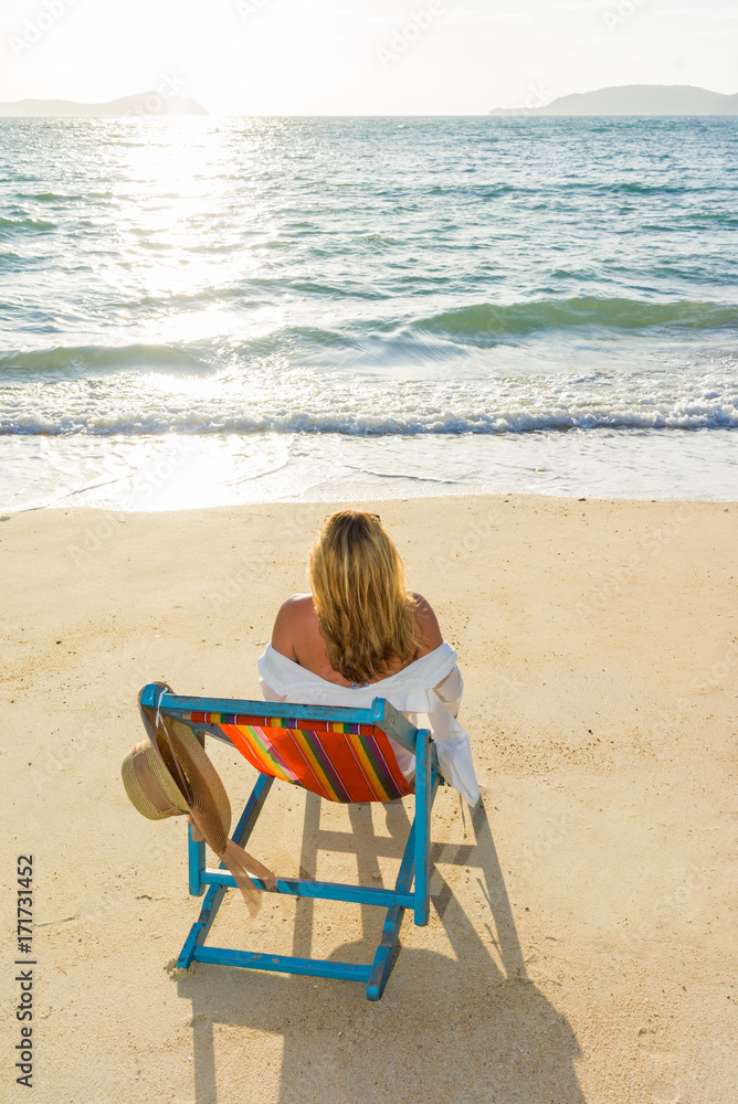 woman relaxing on sun bed sofa lounge chair on holidays woman relaxing on sun bed sofa lounge chair on holidays