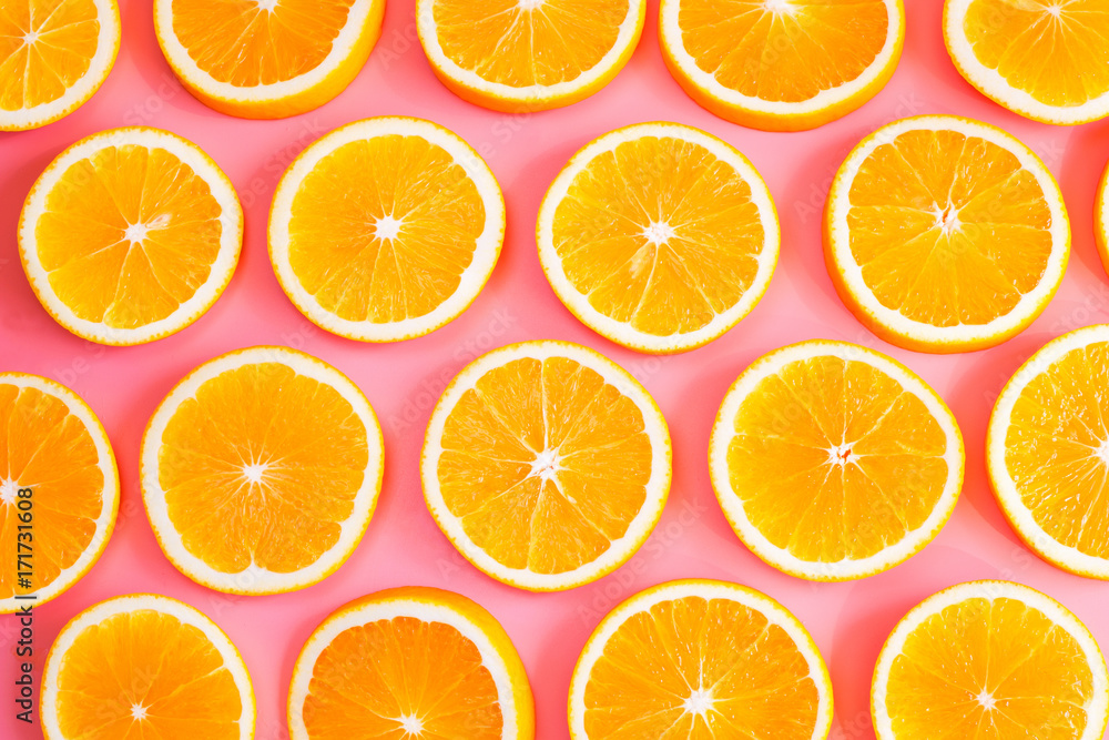 Fresh cut oranges on pink background. Top view. Fresh cut oranges on pink background. Top view.