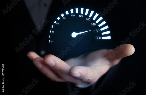 Man holding car speedometer. Speed concept.