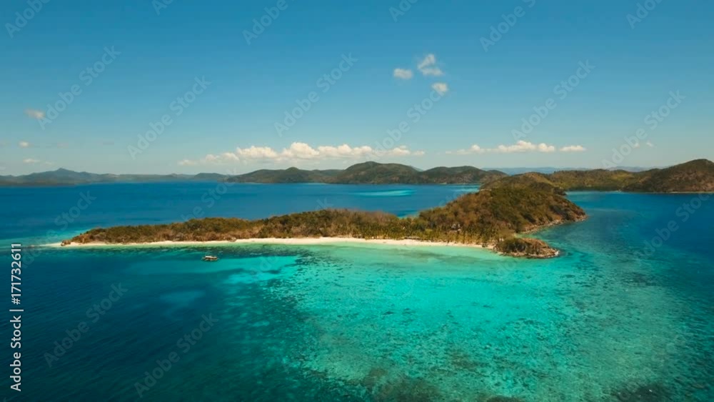 Aerial view of tropical beach on the island Malcapuya, Palawan, Philippines. Beautiful tropical island with sand beach, palm trees. Tropical landscape: beach with palm trees. Seascape: Ocean, sky, sea Aerial view of tropical beach on the island Malcapuya, Palawan, Philippines. Beautiful tropical island with sand beach, palm trees. Tropical landscape: beach with palm trees. Seascape: Ocean, sky, sea