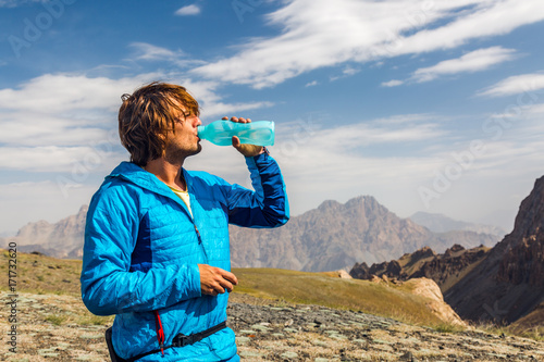 a man drink water during hiking