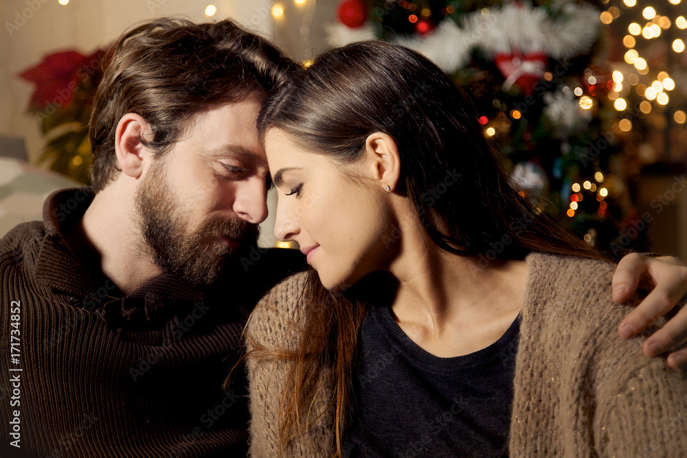 Man and woman looking into each other eyes in love christmas night medium shot Man and woman looking into each other eyes in love christmas night medium shot