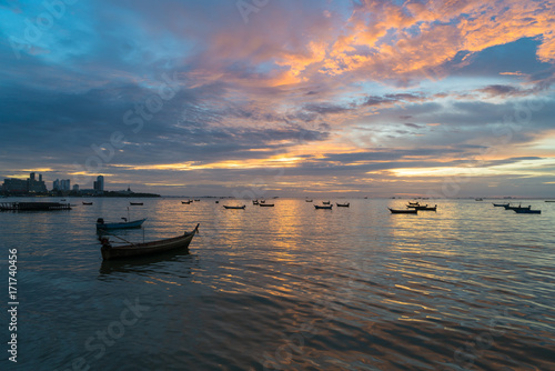 Many Thai fishing boat mooring in sea near Pattaya, Thailand at sunset. © ake1150