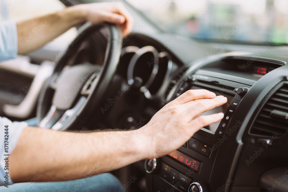 Man using navigation system while driving car Man using navigation system while driving car