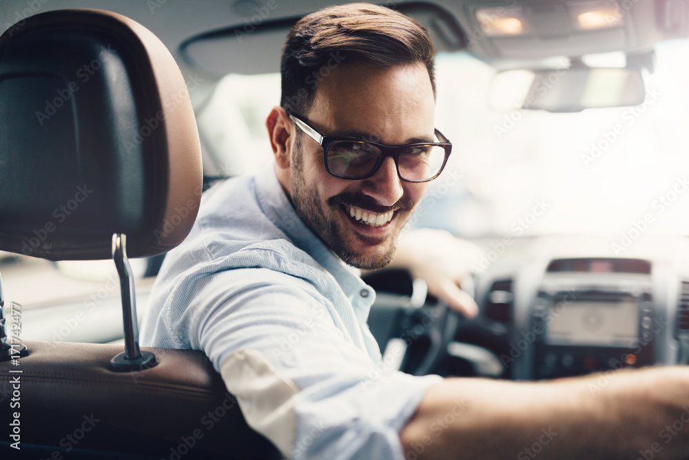 Handsome businessman driving a car