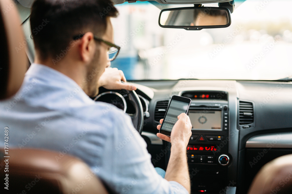 man using phone while driving the car man using phone while driving the car