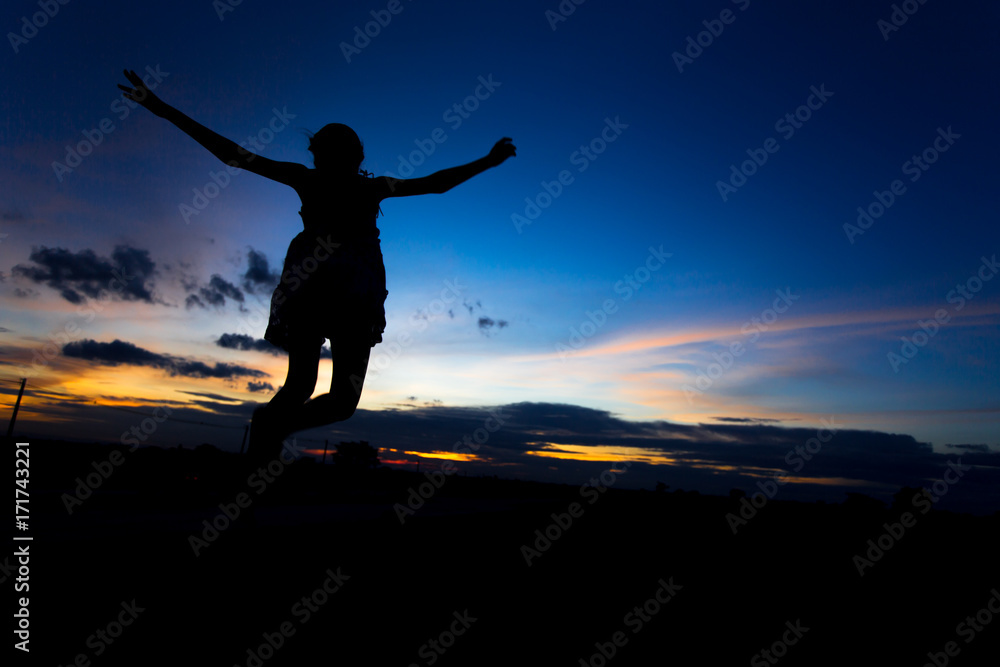 Silhouette of woman posing at sunset or sunrise