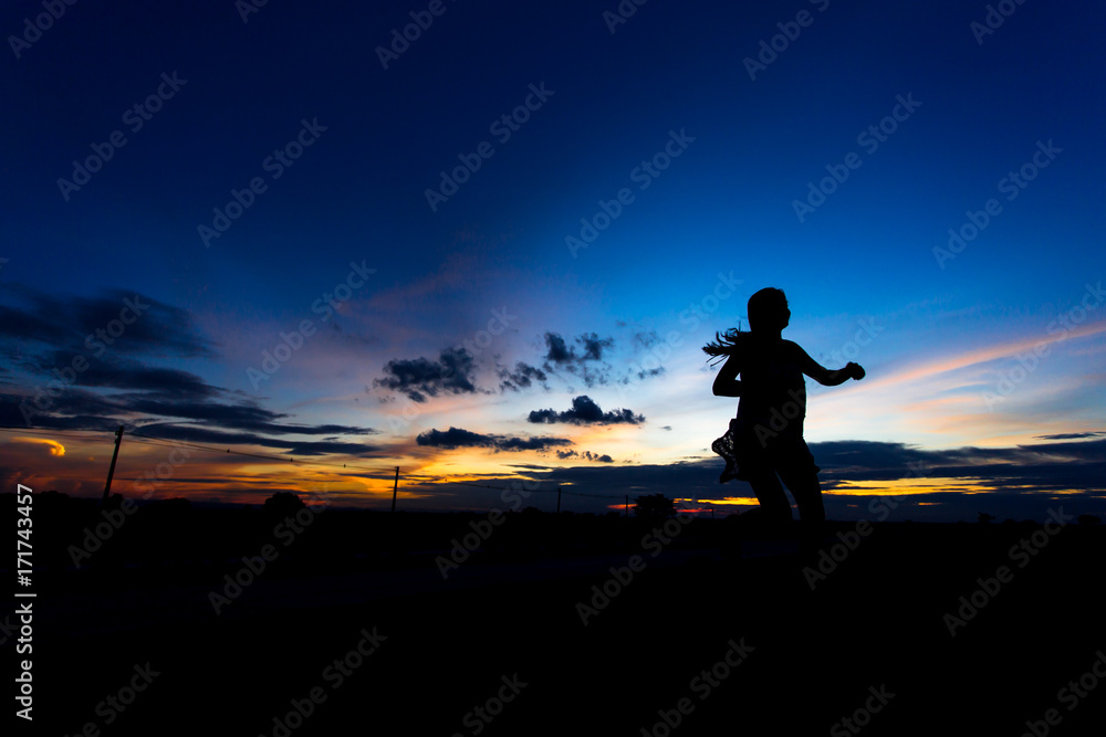 Silhouette of woman posing at sunset or sunrise Silhouette of woman posing at sunset or sunrise