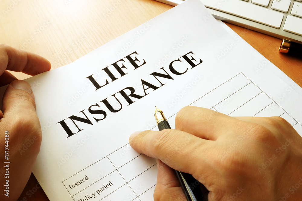 Life insurance policy on a table. Life insurance policy on a table.