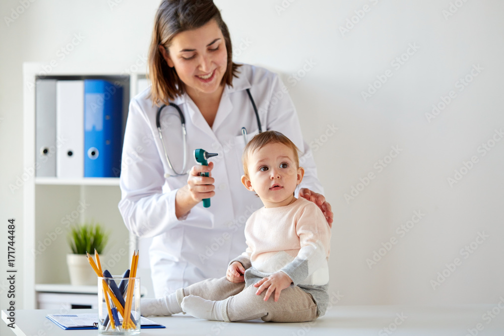 doctor with baby and otoscope at clinic doctor with baby and otoscope at clinic