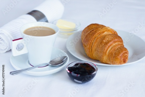 Fototapeta Naklejka Na Ścianę i Meble -   Coffee and croissant with butter and blueberry jam