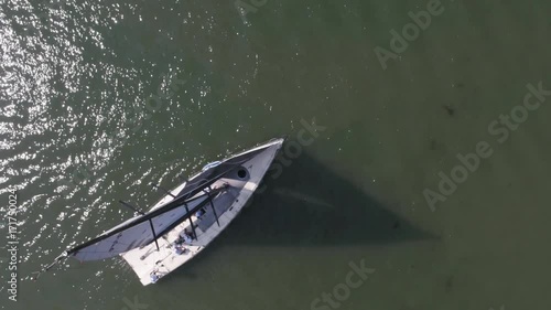 Sailboat in the sea near the port. Footage. White sailboat in the sea photo