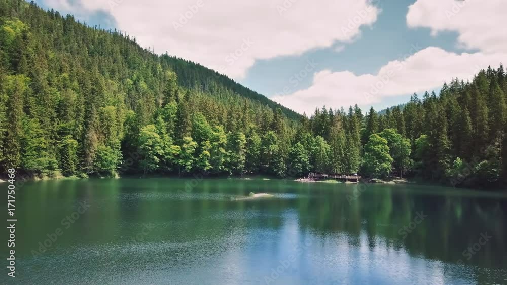 Aerial flythrough of beautiful mountains and forest and lake Aerial flythrough of beautiful mountains and forest and lake