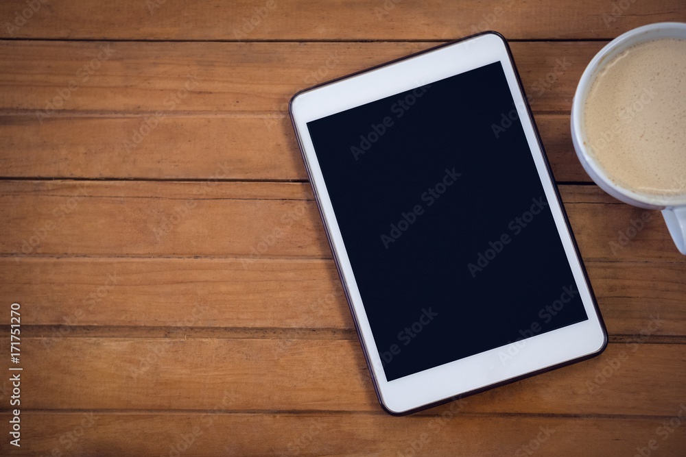 Digital tablet with coffee cup Digital tablet with coffee cup