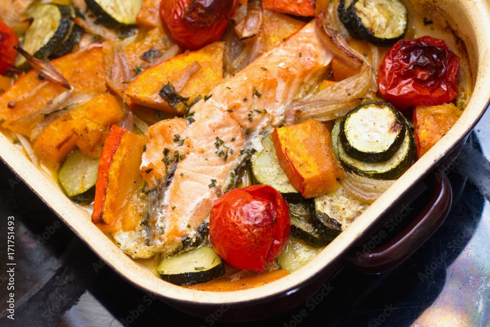 Homemade roasted salmon and vegetables in a baking tray Homemade roasted salmon and vegetables in a baking tray