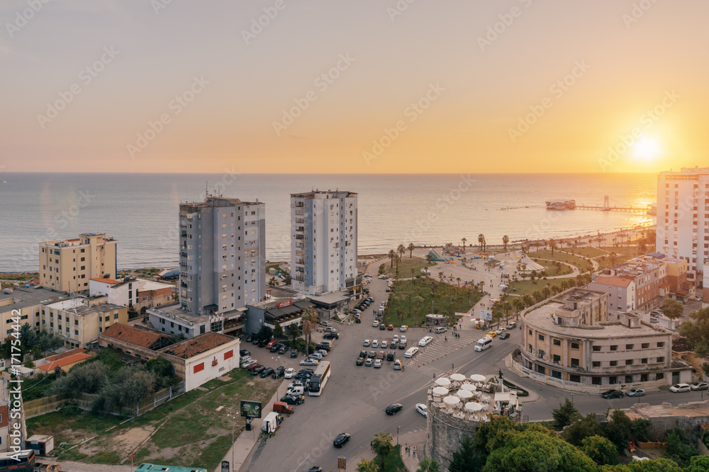 View from above on the embankment of the seaside town of Durres located on the Adriatic coast. Sunset sunset overlooking the Venetian Tower with a cafe on the roof.