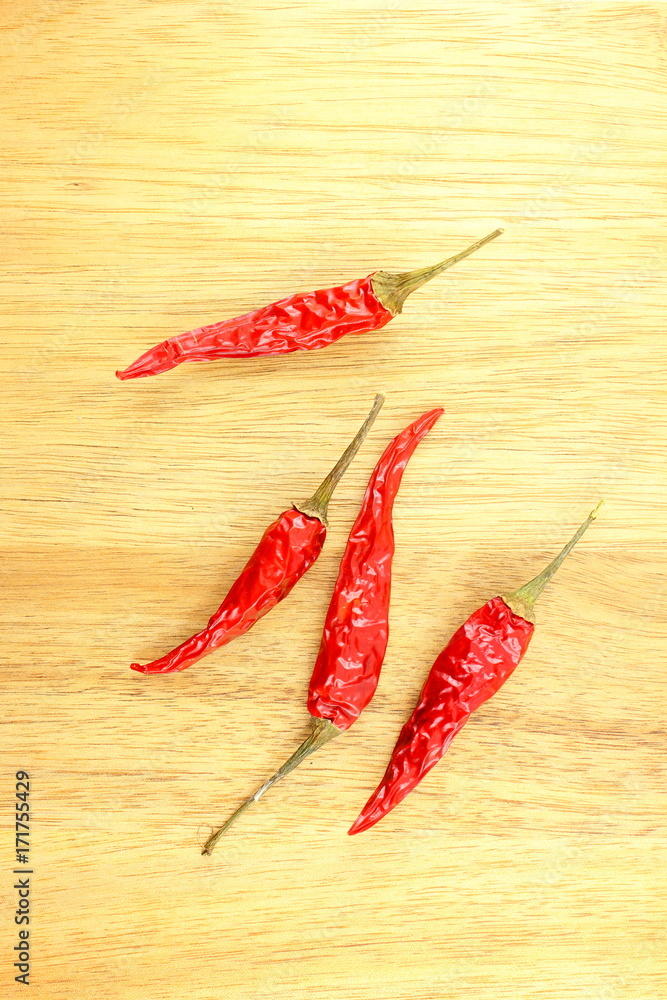 dried thai chili peppers on a wooden board with copyspace dried thai chili peppers on a wooden board with copyspace