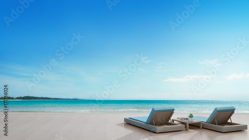Fototapeta Naklejka Na Ścianę i Meble -  Sea view terrace and beds in modern luxury beach house with blue sky background, Lounge chairs on wooden deck at vacation home or hotel - 3d illustration of tourist resort
