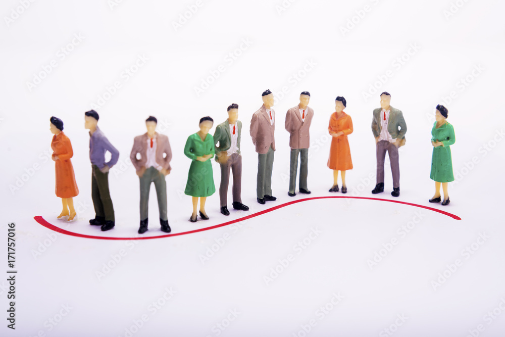 Group of miniature people over white background standing in line or circle. Group of miniature people over white background standing in line or circle.