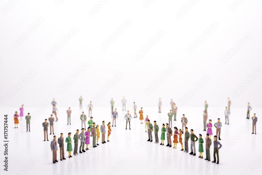 Miniature people in two lines across to each other over white background. Miniature people in two lines across to each other over white background.