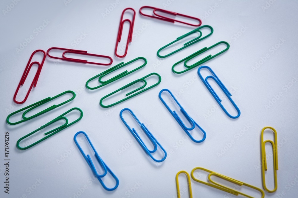 Colorful paper clips arranged on white background Colorful paper clips arranged on white background