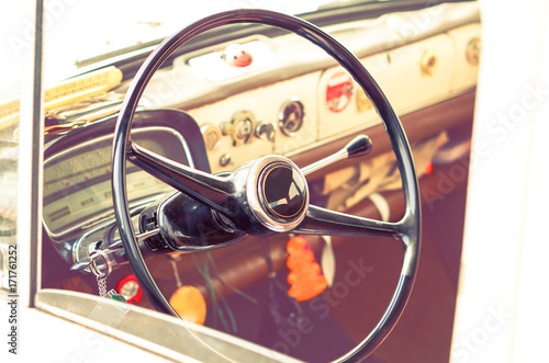 Vintage car steering wheel and dashboard cabin view 