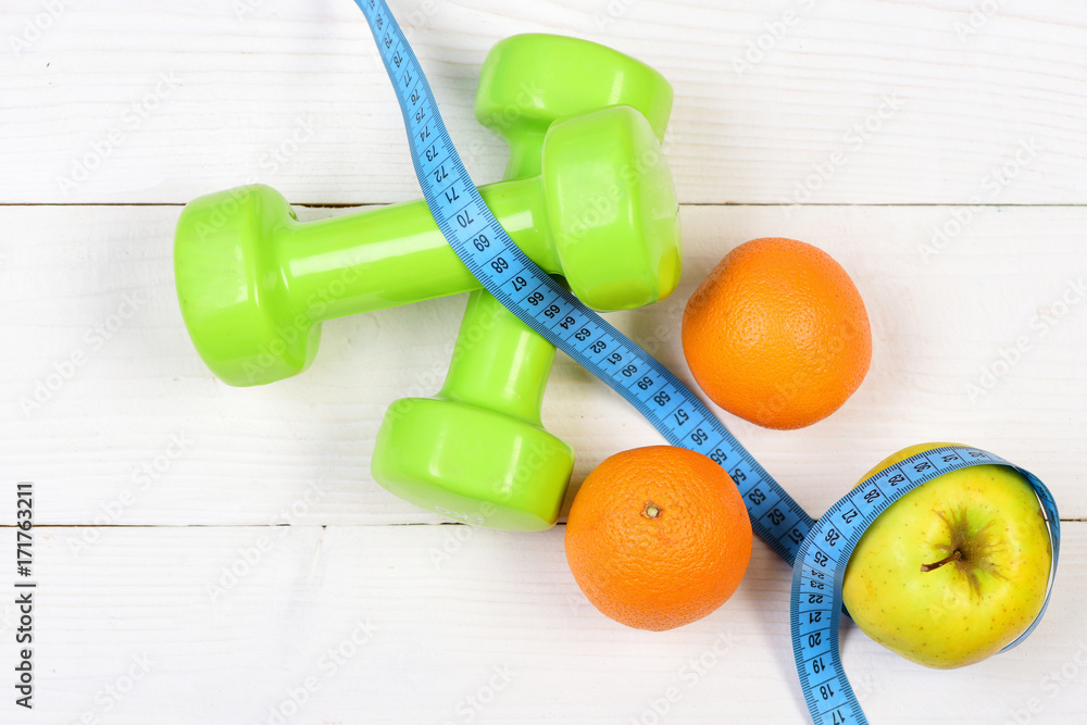 ideal size concept, dumbbells weight with measuring tape, fruit ideal size concept, dumbbells weight with measuring tape, fruit