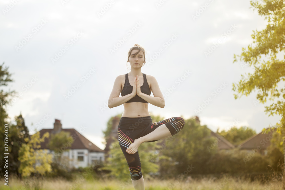 Young woman doing yoga and meditating in park Young woman doing yoga and meditating in park