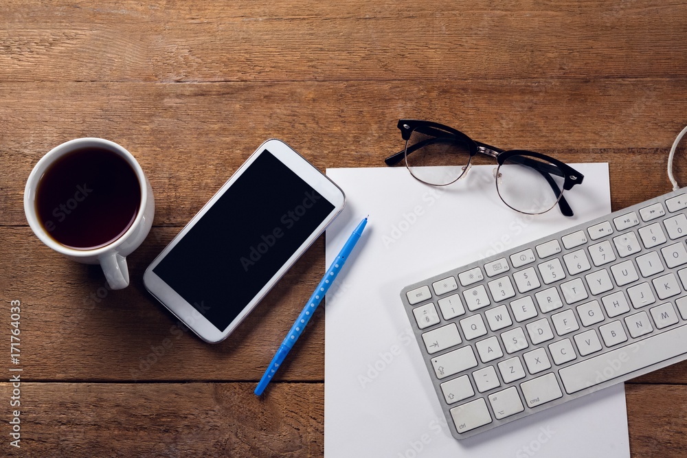 Mobile phone, keyboard, paper, spectacles, pen and coffee on Mobile phone, keyboard, paper, spectacles, pen and coffee on