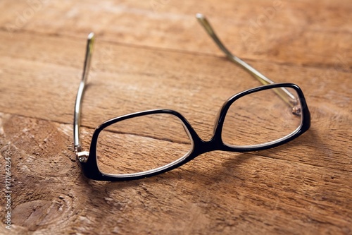 Spectacles on wooden table