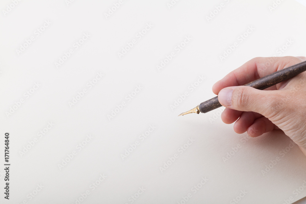 Hand with fountain pen on the white sheet Hand with fountain pen on the white sheet