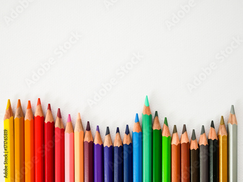 seamless colored pencils row on white painting paper background