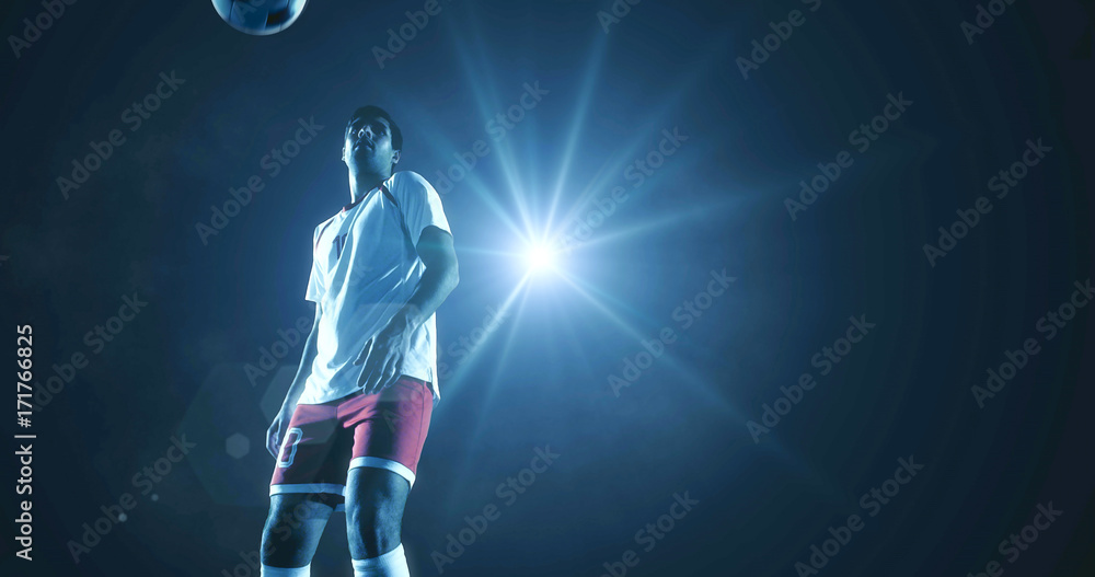 Soccer player kicks the ball on the soccer stadium. He wear unbranded sports clothes. Stadium and crowd made in 3D.