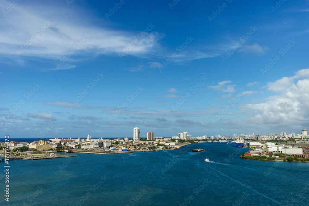Scenic view of historic colorful Puerto Rico city in distance from the sea with the port in foreground