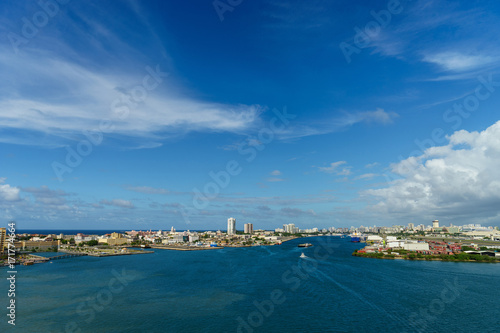 Scenic view of historic colorful Puerto Rico city in distance from the sea with the port in foreground
